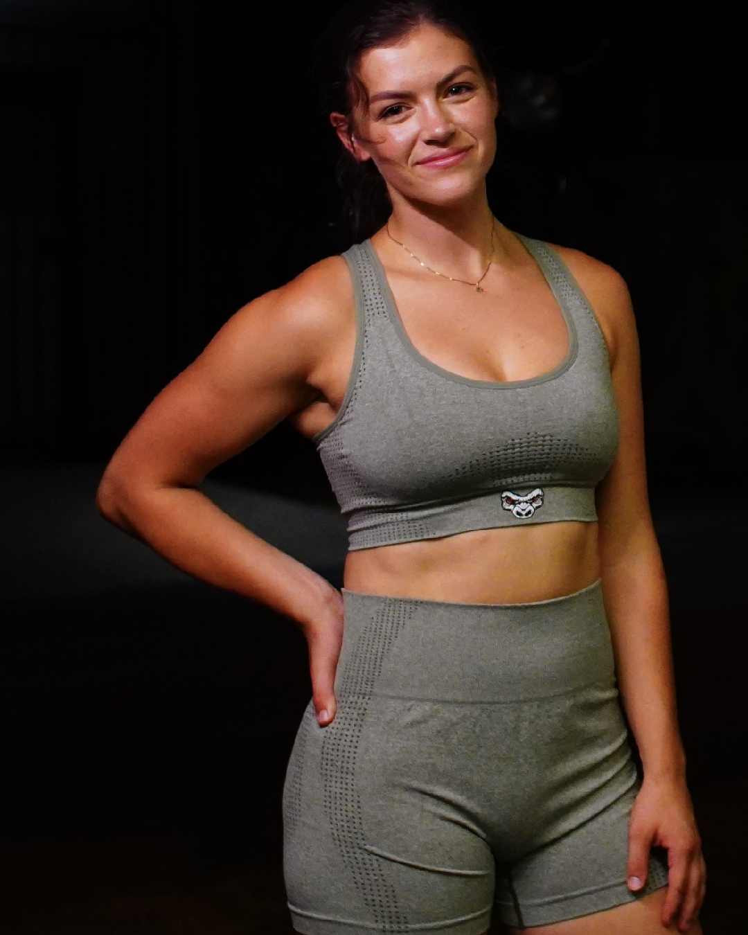 woman wearing Last Rep olive green bike shorts and sports bra yoga set
