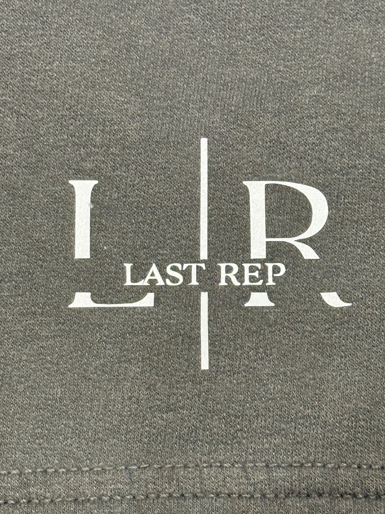 Gray fabric with 'LR Last Rep' logo printed on it