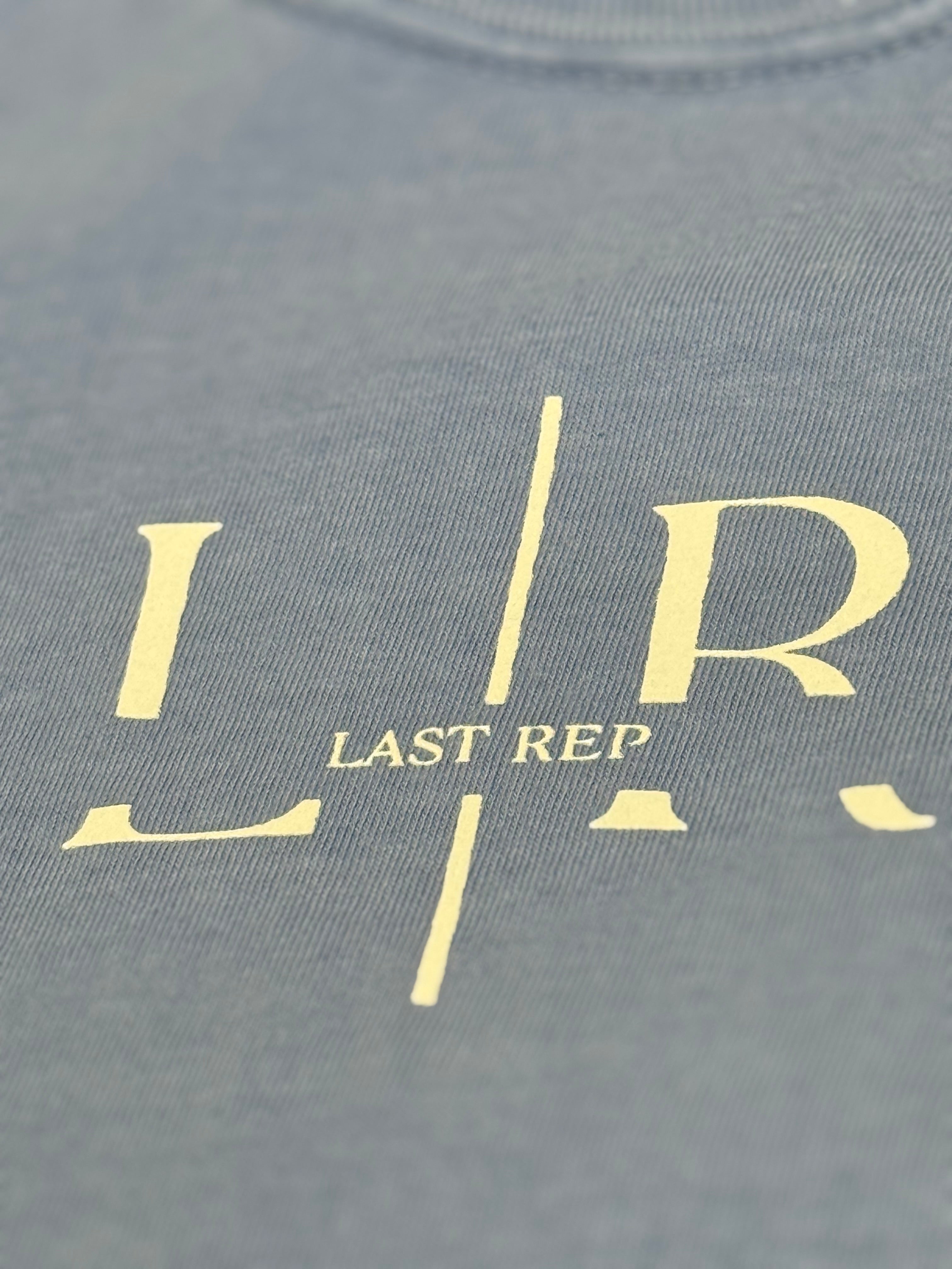 washed denim t-shirt with 'LR' logo and 'LAST REP' text in gold on a gray background