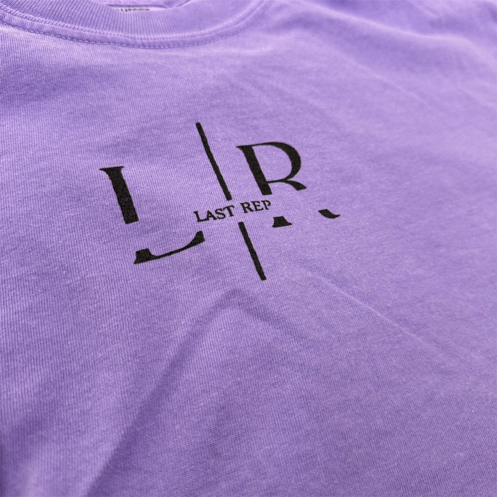 Purple shirt with black logo and text 'LR LAST REP' on a plain background