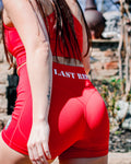 Person wearing a red outfit with 'LAST REP' text, standing outdoors.
