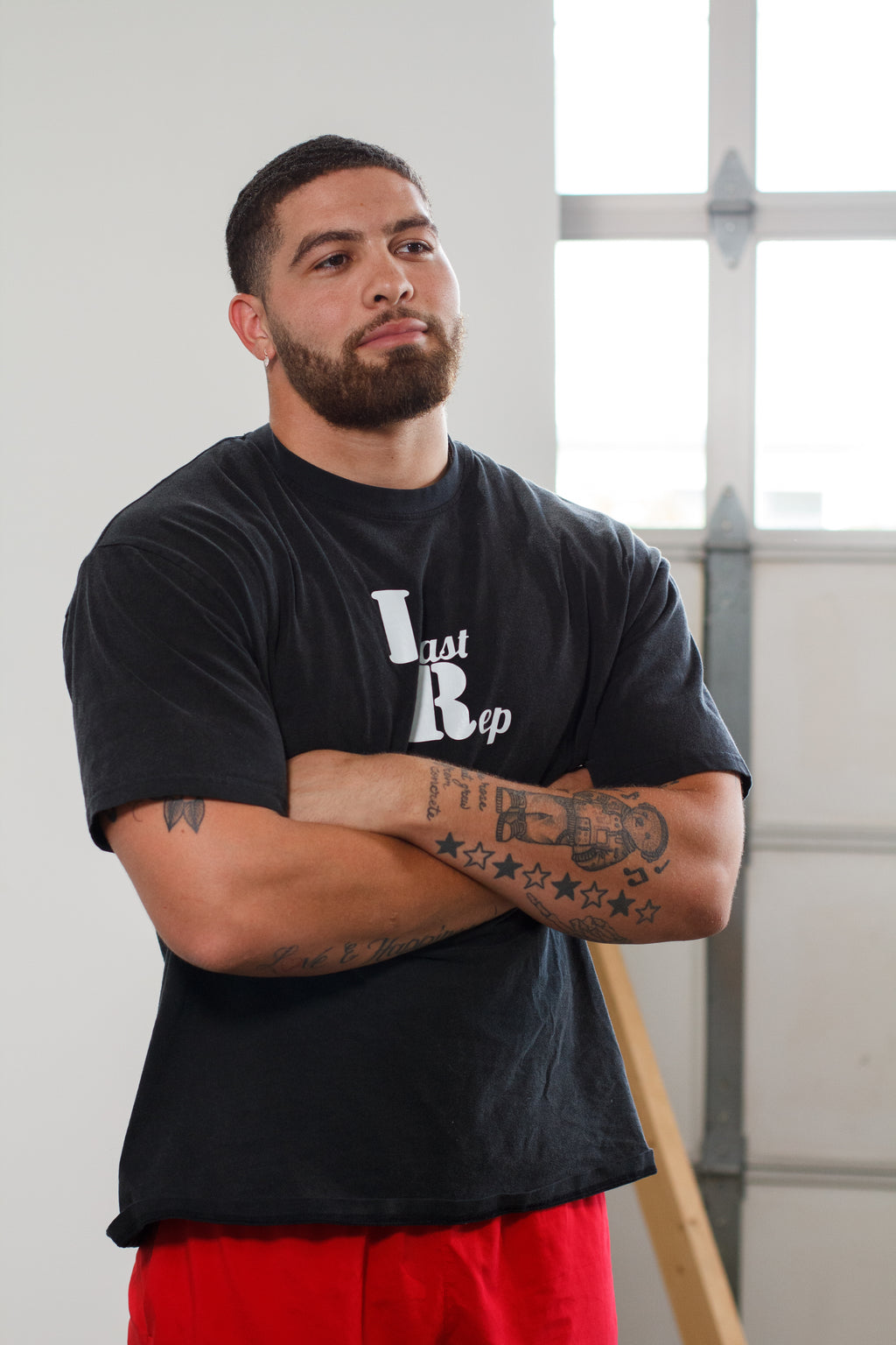 man wearing black pump cover with Last Rep logo