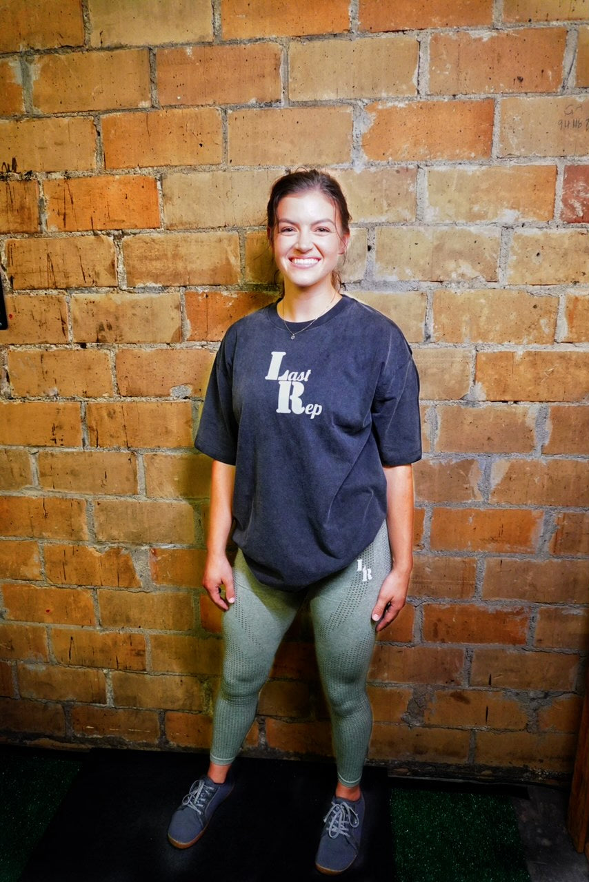 woman wearing black Last Rep pump cover with olive green leggings